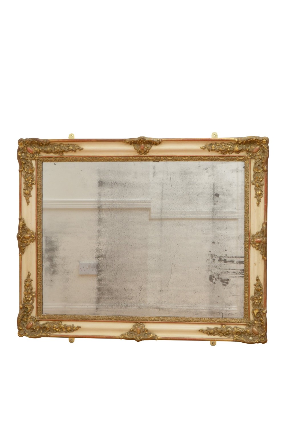 A rectangular 19th-century French Rococo wall mirror featuring an off-white frame decorated with ornate gold gilt gesso scrollwork and corner cartouches surrounding an aged glass plate. View V