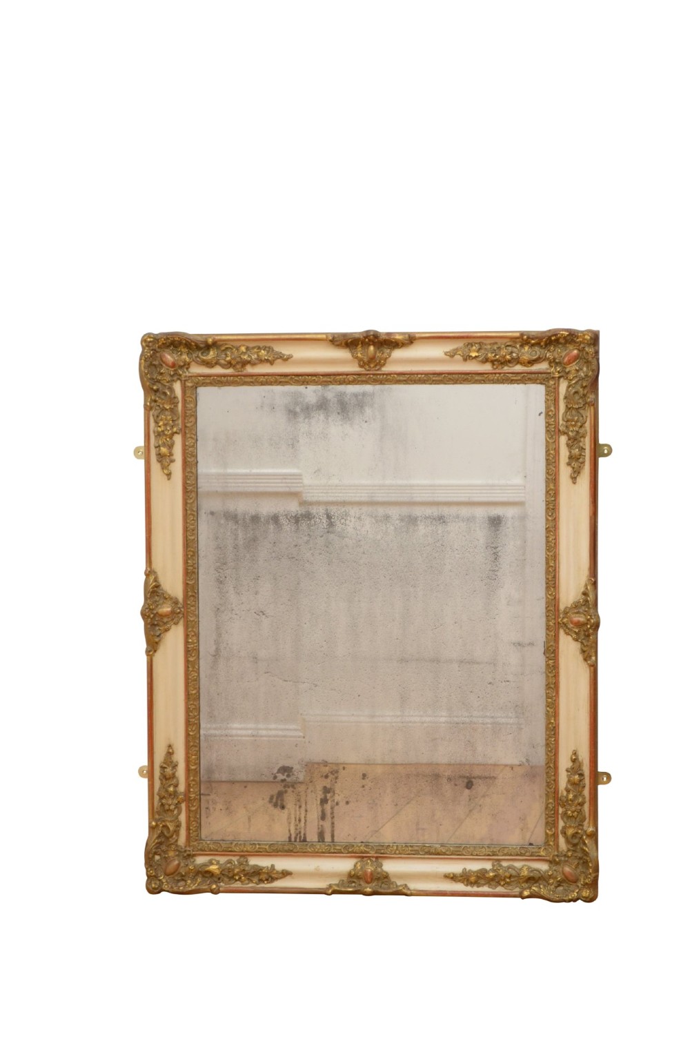 A rectangular 19th-century French Rococo wall mirror featuring an off-white frame decorated with ornate gold gilt gesso scrollwork and corner cartouches surrounding an aged glass plate.