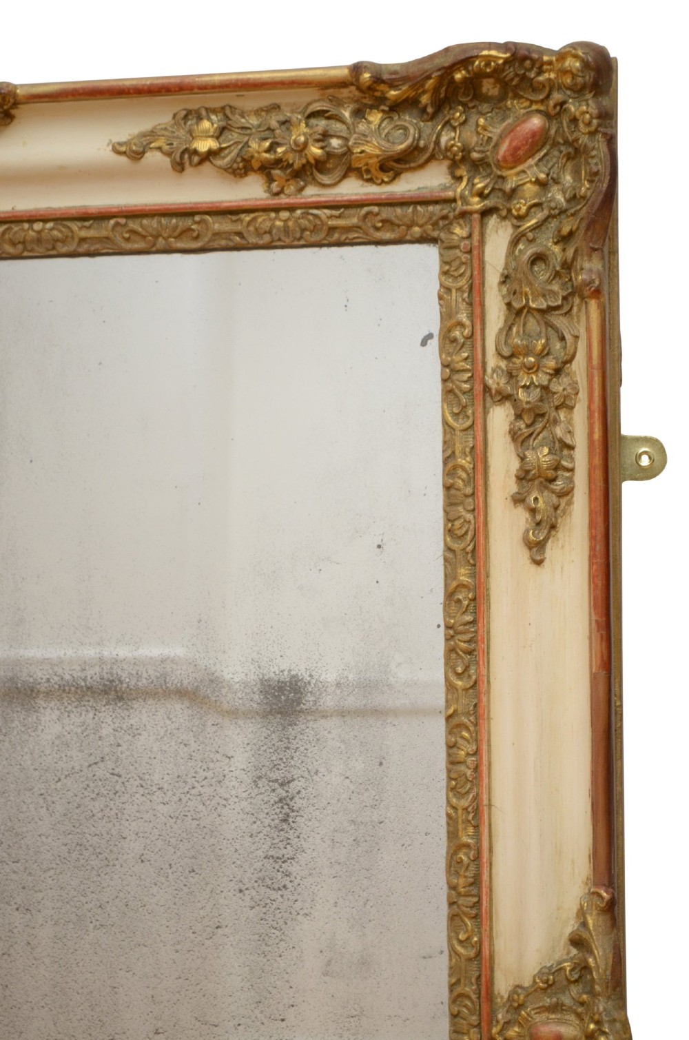 A rectangular 19th-century French Rococo wall mirror featuring an off-white frame decorated with ornate gold gilt gesso scrollwork and corner cartouches surrounding an aged glass plate. View X