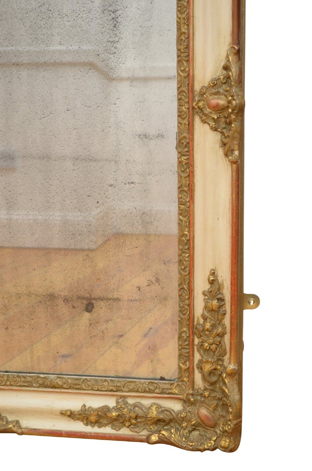 A rectangular 19th-century French Rococo wall mirror featuring an off-white frame decorated with ornate gold gilt gesso scrollwork and corner cartouches surrounding an aged glass plate. View XI