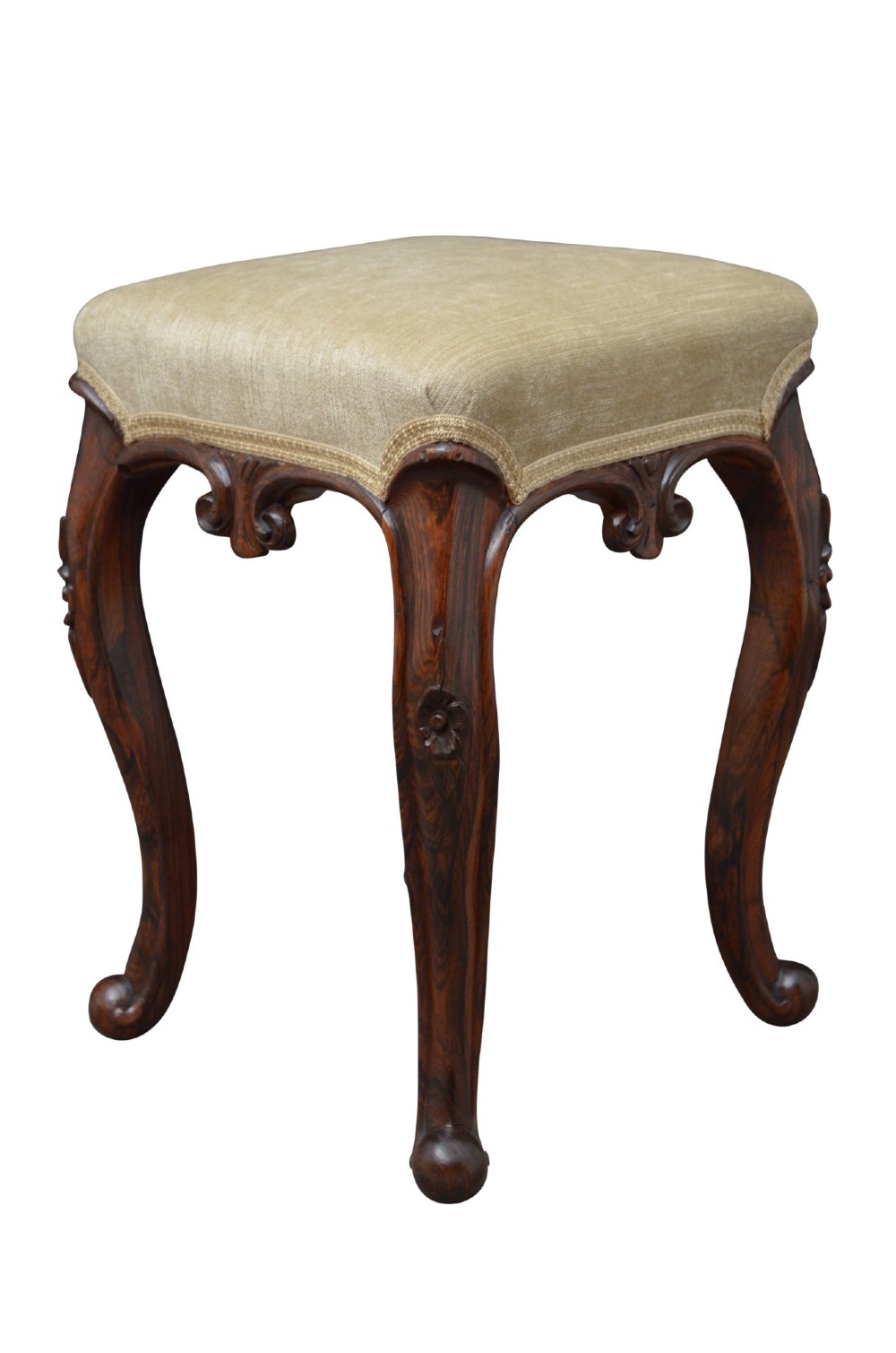 A nineteenth-century Victorian dressing table stool crafted from dark Goncalo Alves wood featuring carved cabriole legs and a cream upholstered padded top. View II