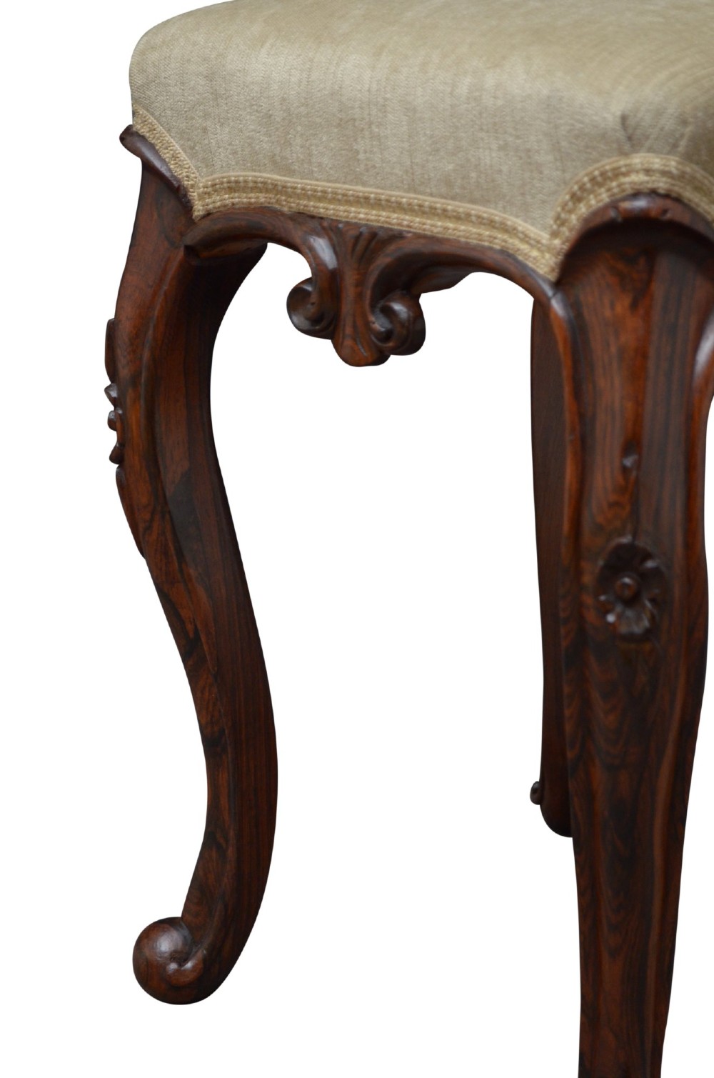 A nineteenth-century Victorian dressing table stool crafted from dark Goncalo Alves wood featuring carved cabriole legs and a cream upholstered padded top. View VII