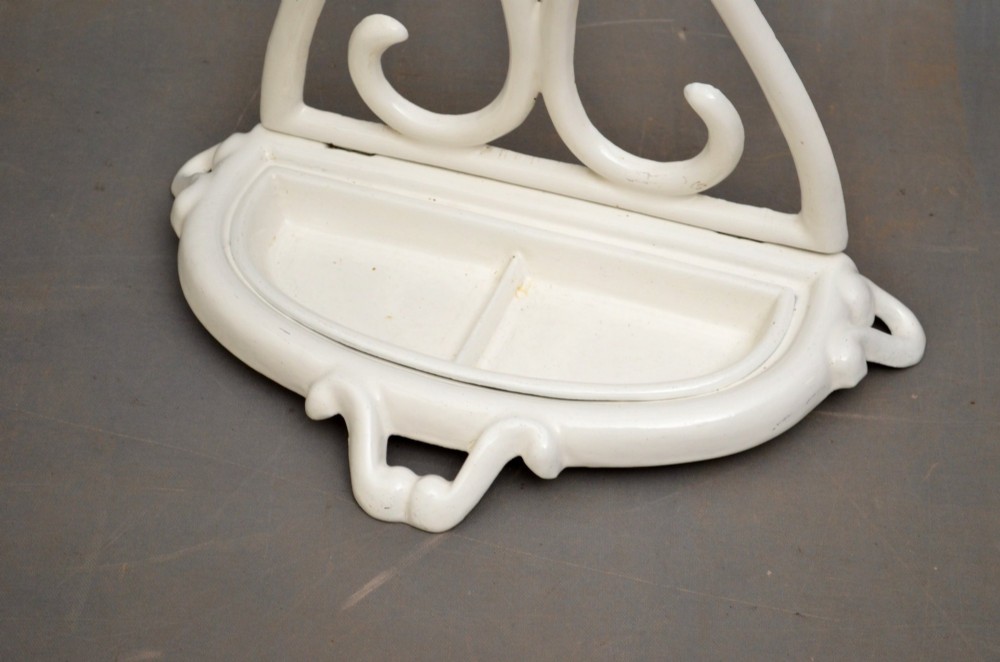 A white enamelled cast iron Art Nouveau umbrella stand featuring fluid scrollwork motifs and an integrated base drip tray. View III