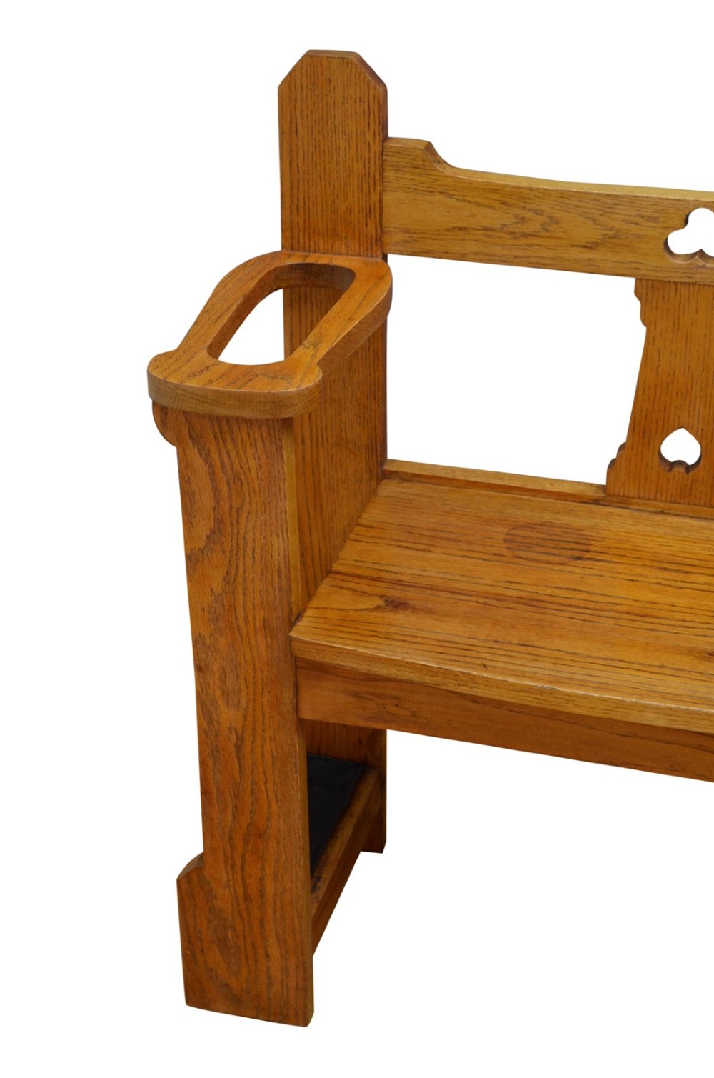 A golden oak Arts and Crafts hall seat featuring a central backboard with a trefoil cut-out, flat armrests with circular stick apertures, and sturdy rectangular uprights. View II