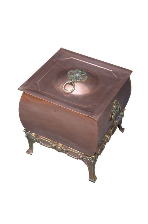 A late Victorian copper square vessel with rounded sides, ornate cast brass handles, decorative feet, and a fitted lid with a brass drop handle.