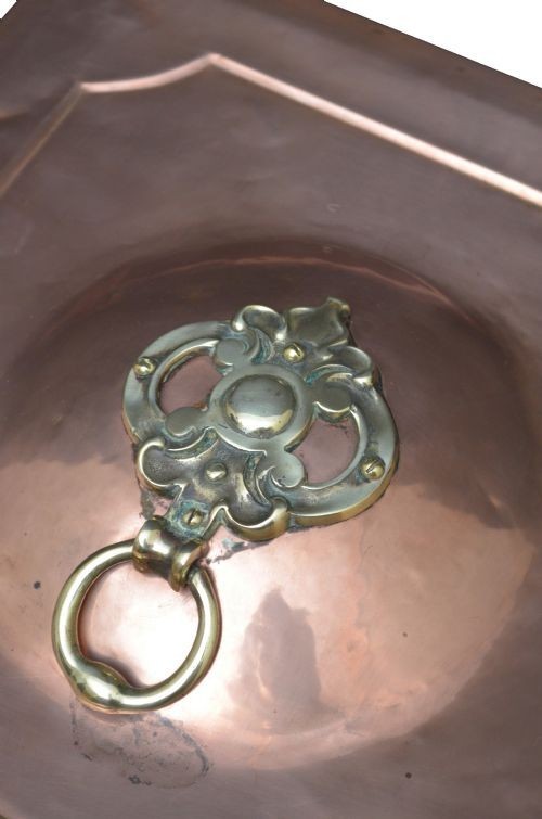 A late Victorian copper square vessel with rounded sides, ornate cast brass handles, decorative feet, and a fitted lid with a brass drop handle. View VIII