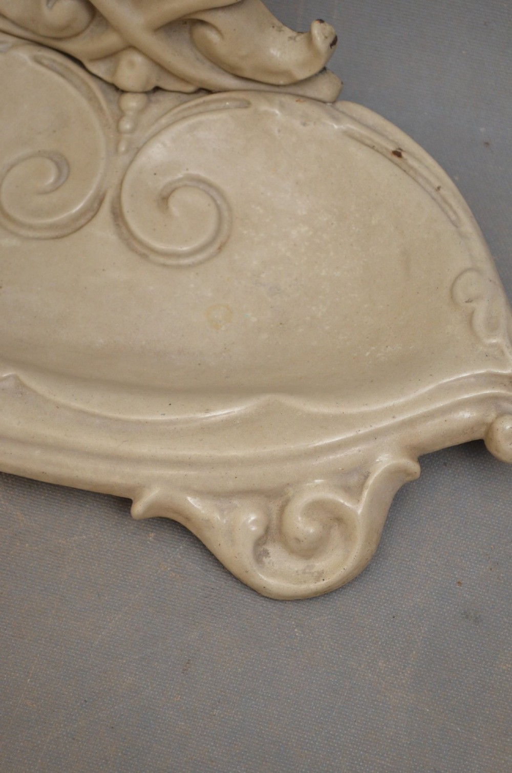An Art Nouveau painted cream cast iron umbrella stand featuring organic scrollwork and an integrated drip tray at the base. View II