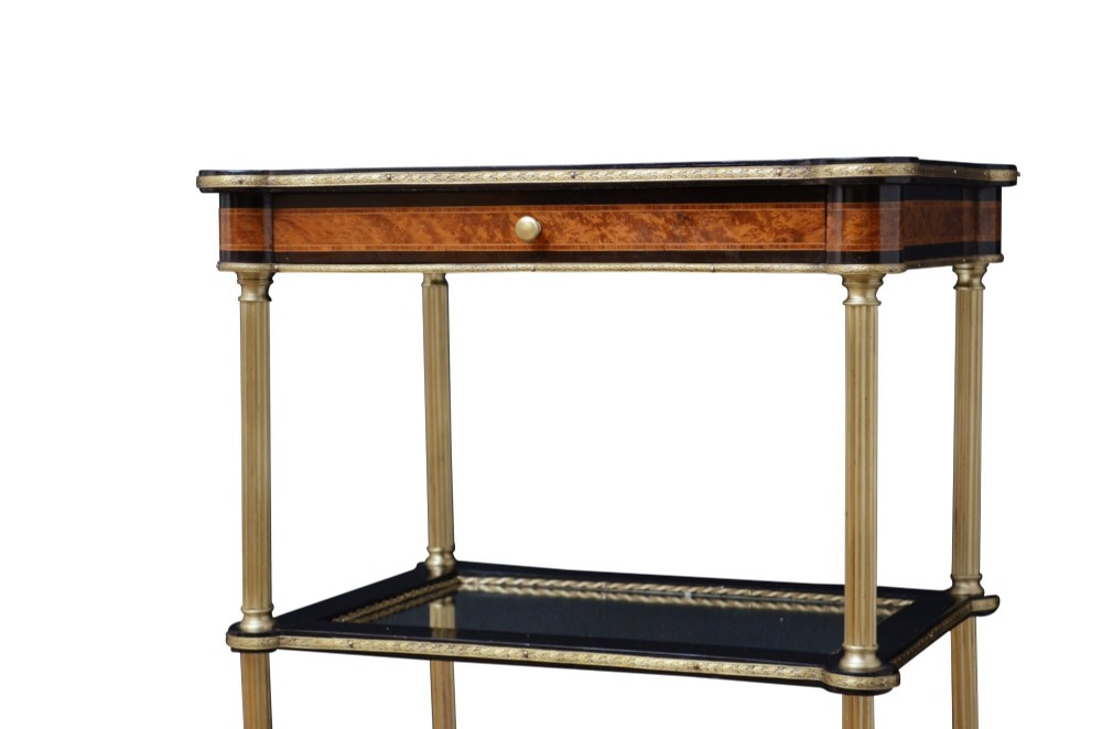 A late nineteenth-century French three-tier lamp table featuring a marquetry inlaid top with foliage border, slender brass columnar supports, two lower mirrored shelves, and brass hoof feet. View VI