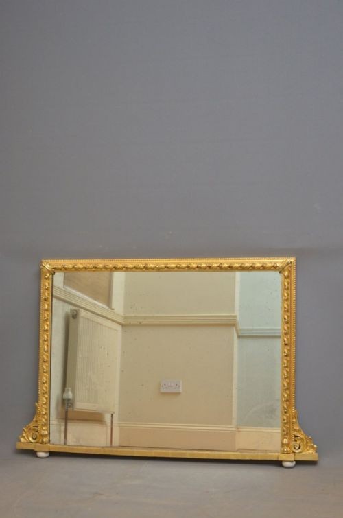 A rectangular Victorian giltwood overmantel mirror with carved rope twist moulding, corner scroll details, and original mirror glass. View VI
