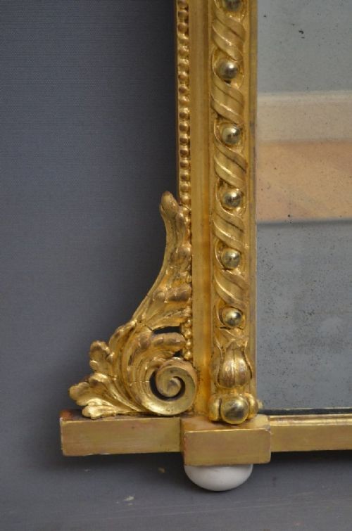 A rectangular Victorian giltwood overmantel mirror with carved rope twist moulding, corner scroll details, and original mirror glass. View IX