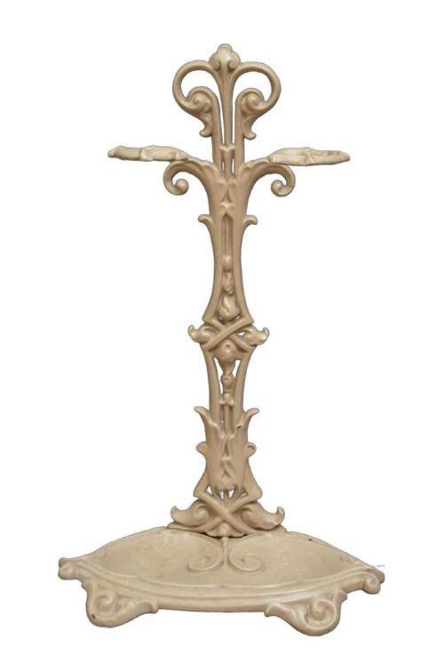 An Art Nouveau painted cream cast iron umbrella stand featuring organic scrollwork and an integrated drip tray at the base. View VI