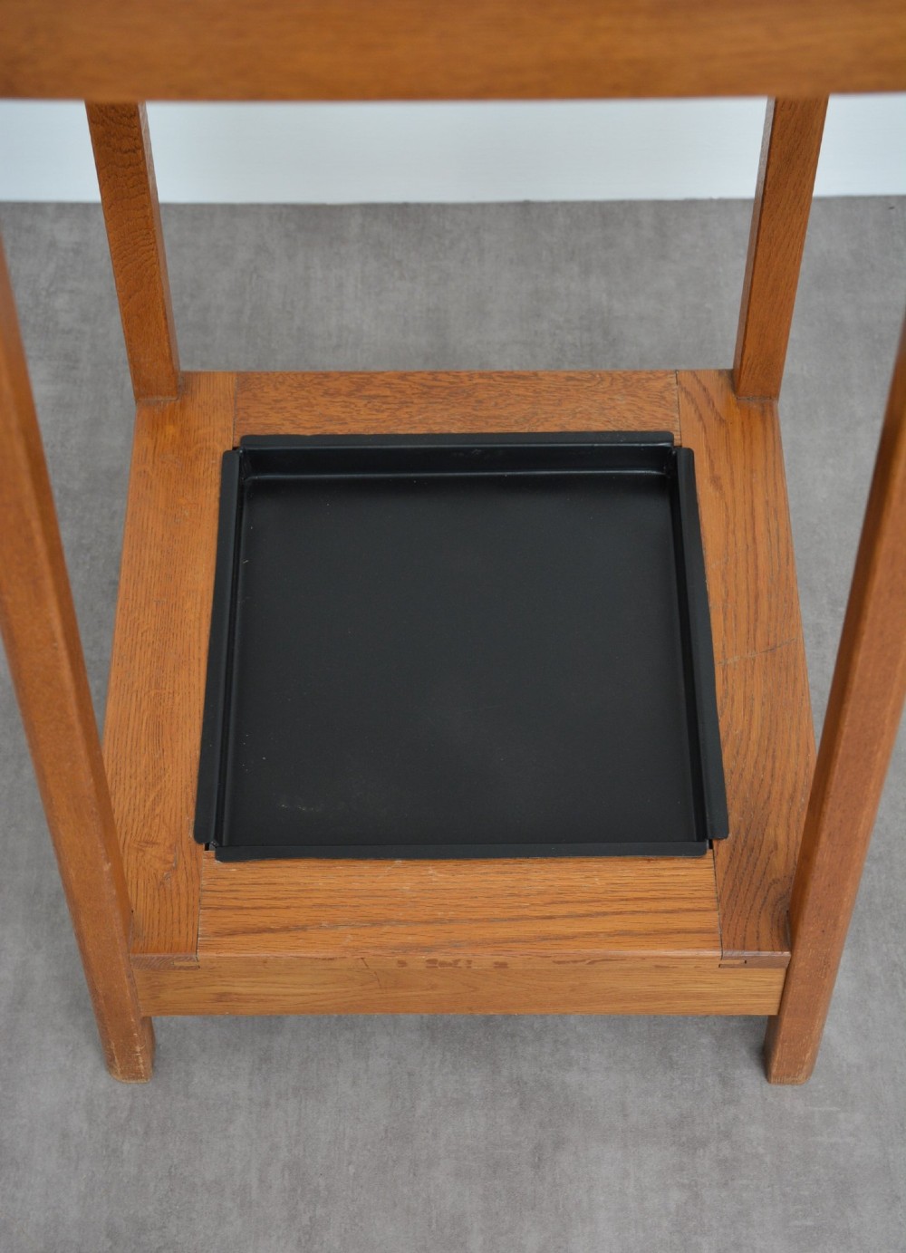 A tall, tapered oak coat stand featuring metal double hooks at the top, a square umbrella retaining rail in the centre, and a dark metal drip tray at the base. View VIII