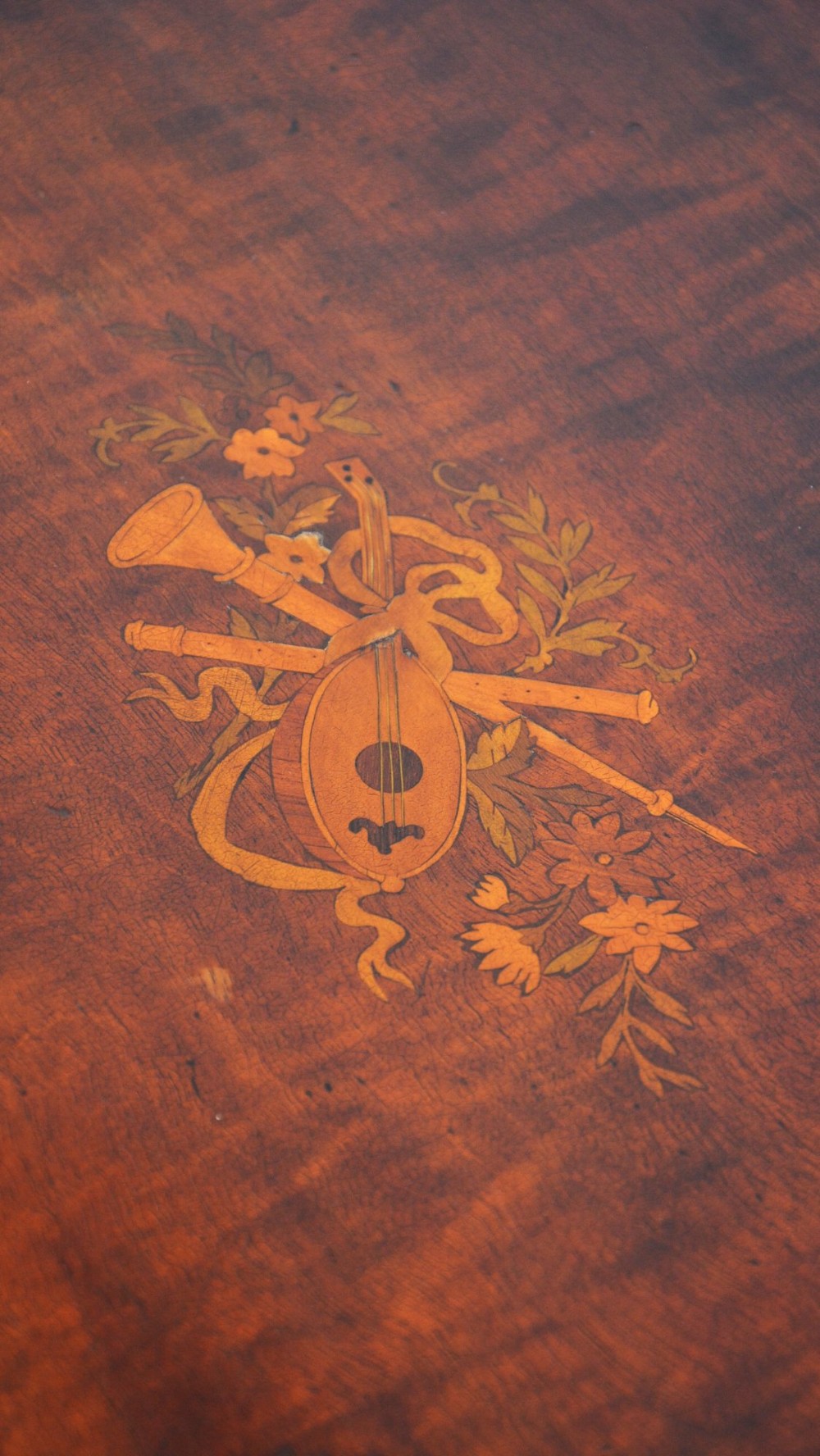 An Edwardian mahogany kidney-shaped side table featuring inlaid marquetry at the centre, fluted turned legs, a curved stretcher, and small brass castors. View VI