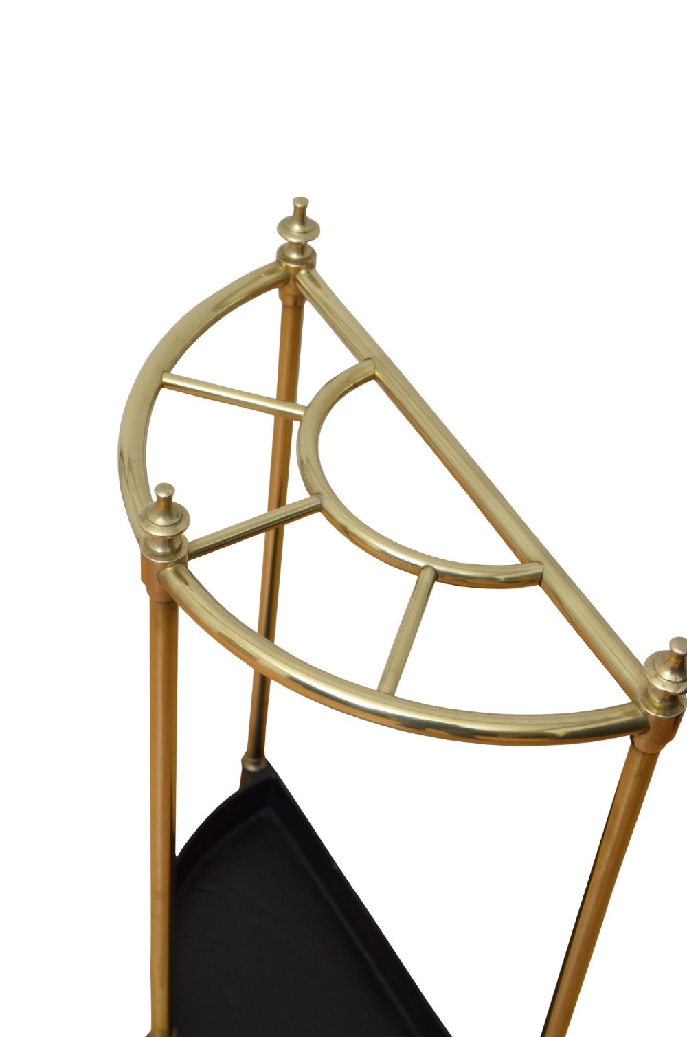 An antique brass demi-lune stick stand featuring three vertical supports, turned finials, a divided top rail, and a semi-circular black cast iron drip tray base. View V