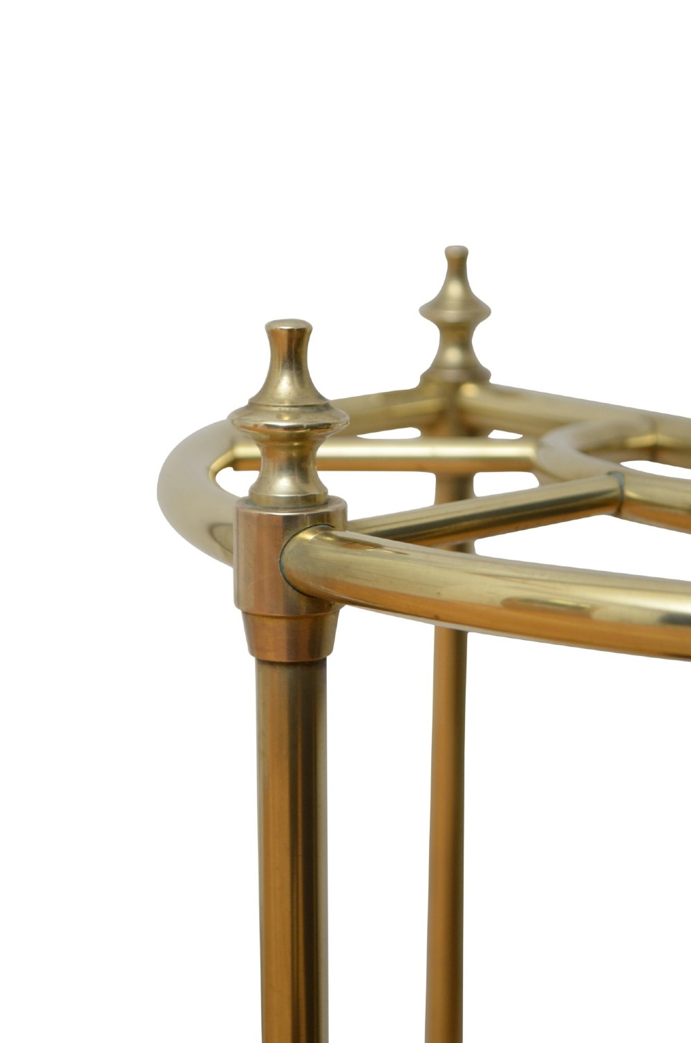 An antique brass demi-lune stick stand featuring three vertical supports, turned finials, a divided top rail, and a semi-circular black cast iron drip tray base. View VI