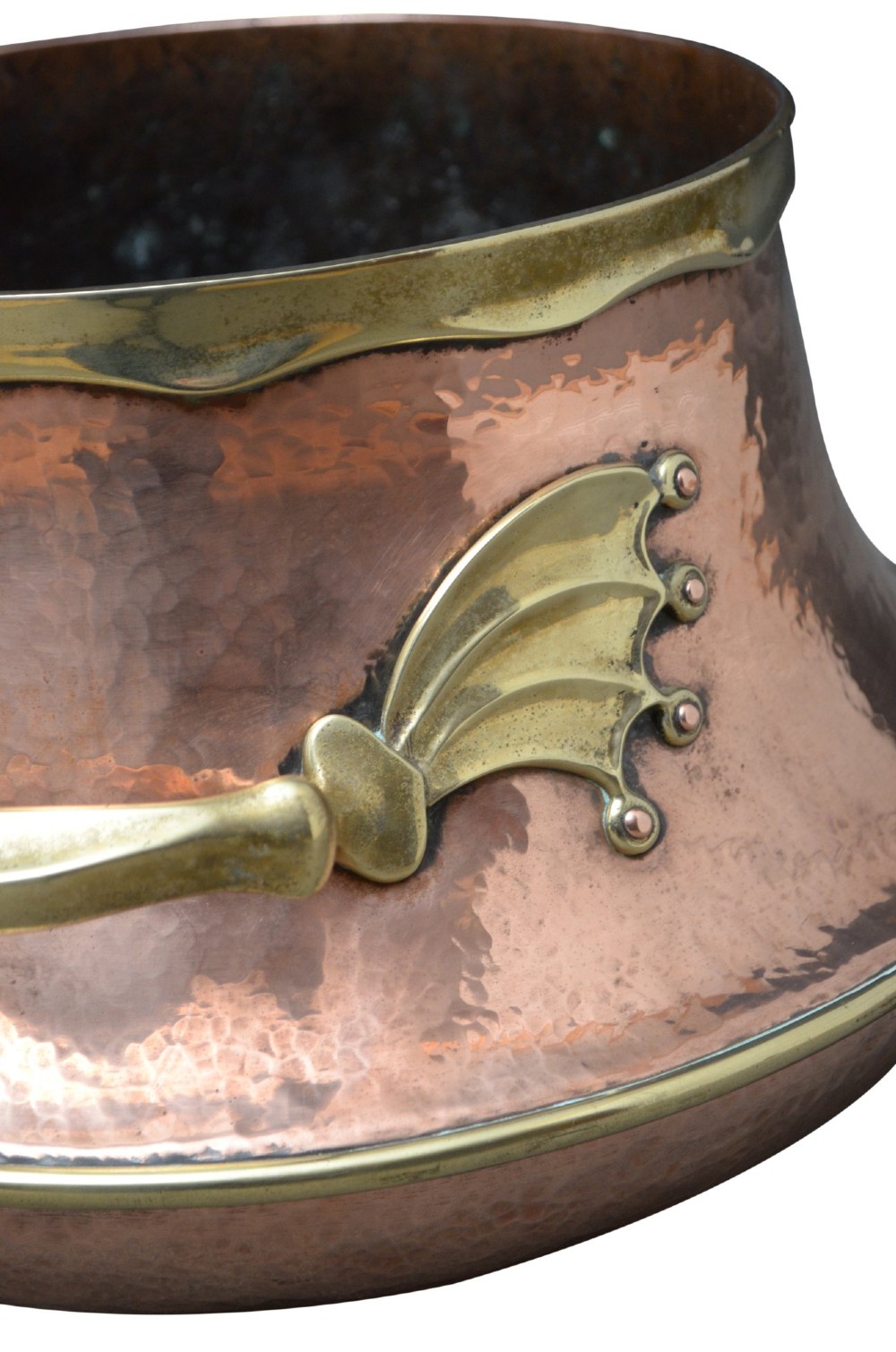 A hand-hammered 19th-century copper jardiniere featuring a broad rim with brass edging and winged cast brass side handles. View V
