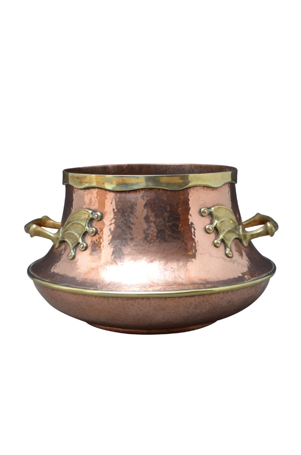 A hand-hammered 19th-century copper jardiniere featuring a broad rim with brass edging and winged cast brass side handles. View VII