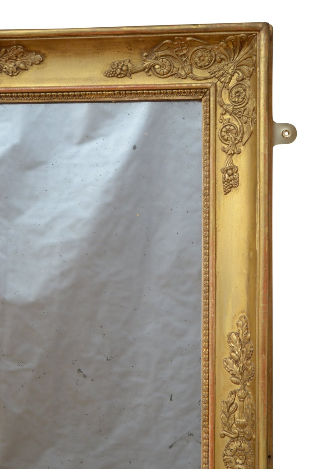 A rectangular French Restoration giltwood wall mirror featuring carved floral mouldings and distressed mirror glass. View VII