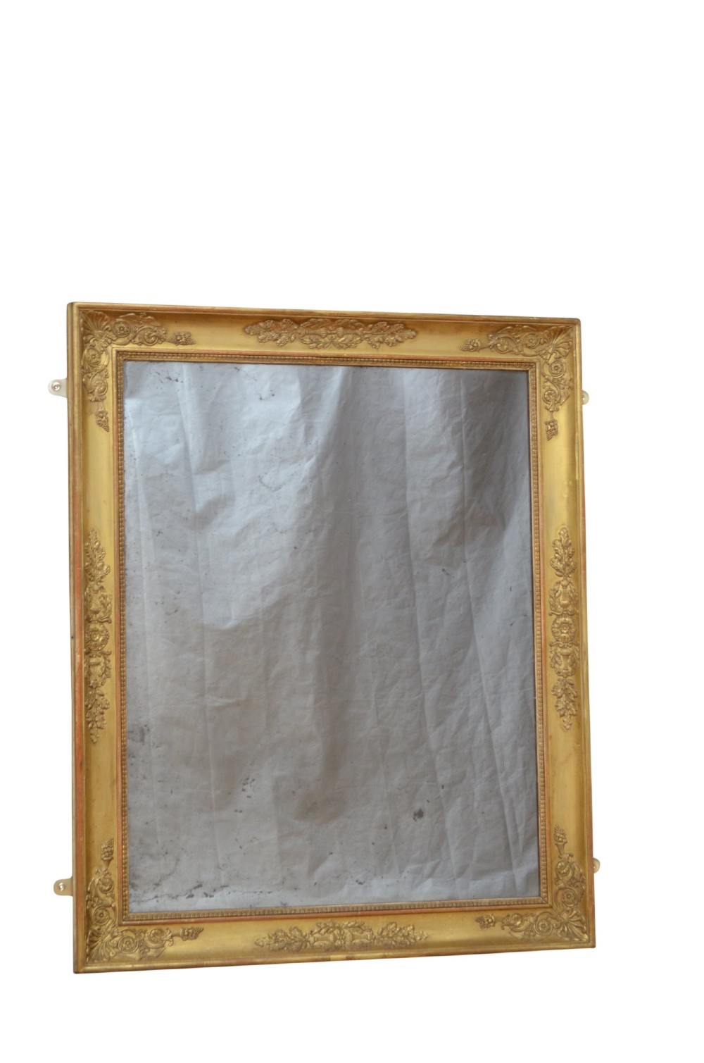 A rectangular French Restoration giltwood wall mirror featuring carved floral mouldings and distressed mirror glass. View X