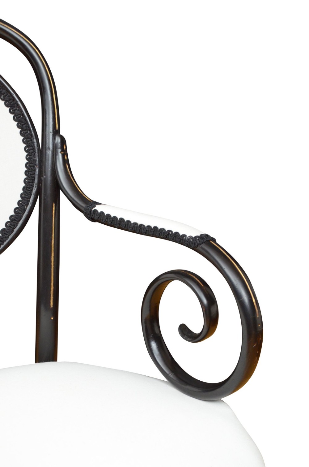 An ebonised steam-bent wood settee with a cream upholstered backrest and seat cushion. View VII