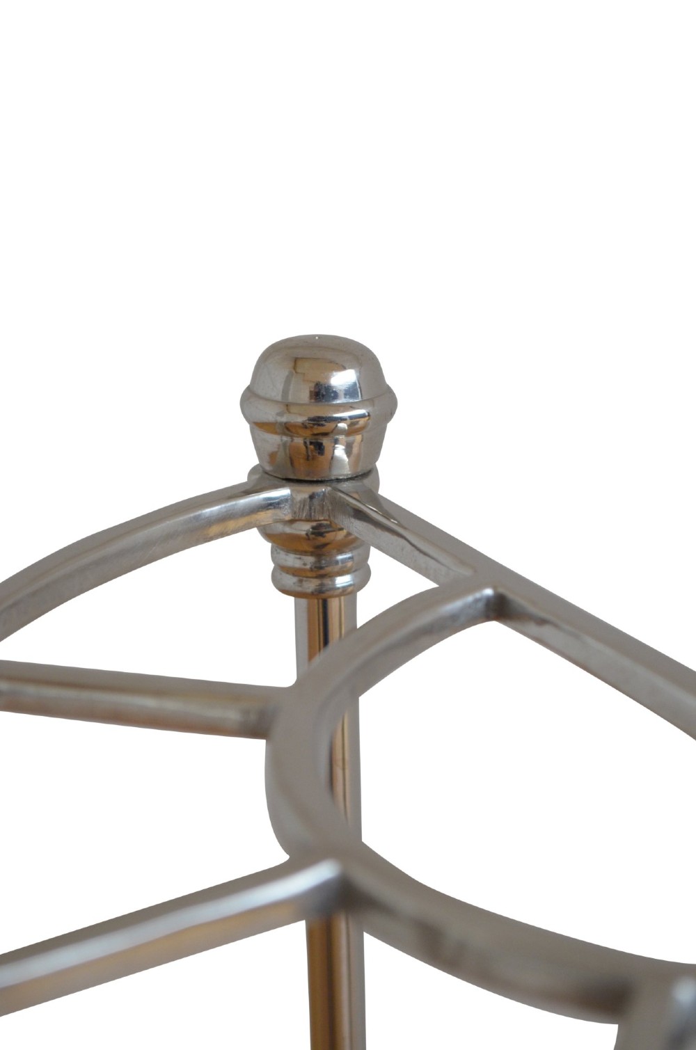 An Art Deco demi-lune nickel-plated umbrella stand featuring a semi-circular top frame with five divisions, vertical support rods with spherical finials, and a black cast iron drip tray base. View VI