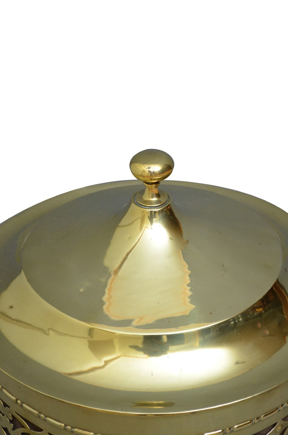 A cylindrical Edwardian polished brass coal bucket featuring a fretwork band, domed lid with finial, and three cast fluted feet. View IV