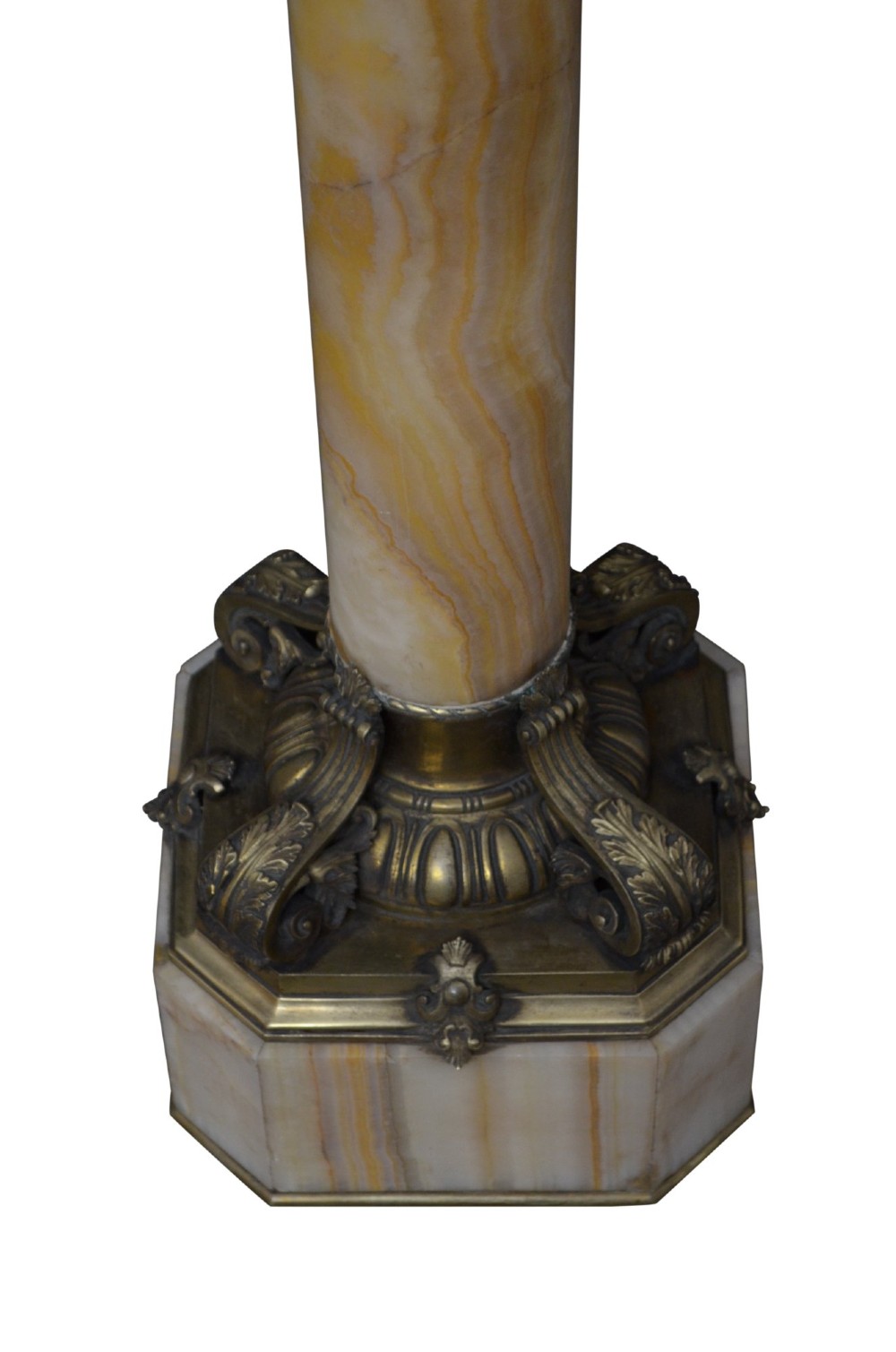 A tall cylindrical cream and amber onyx column featuring gilt bronze ormolu mounts at the top and base, set on a square plinth. View VII