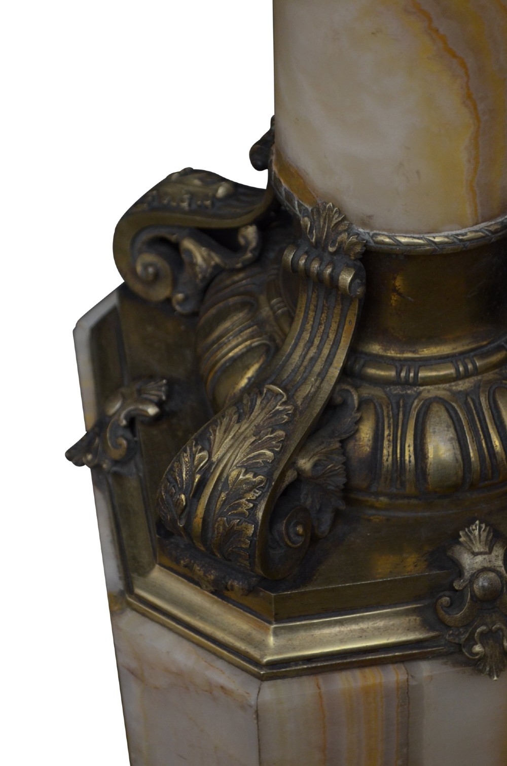 A tall cylindrical cream and amber onyx column featuring gilt bronze ormolu mounts at the top and base, set on a square plinth. View VIII