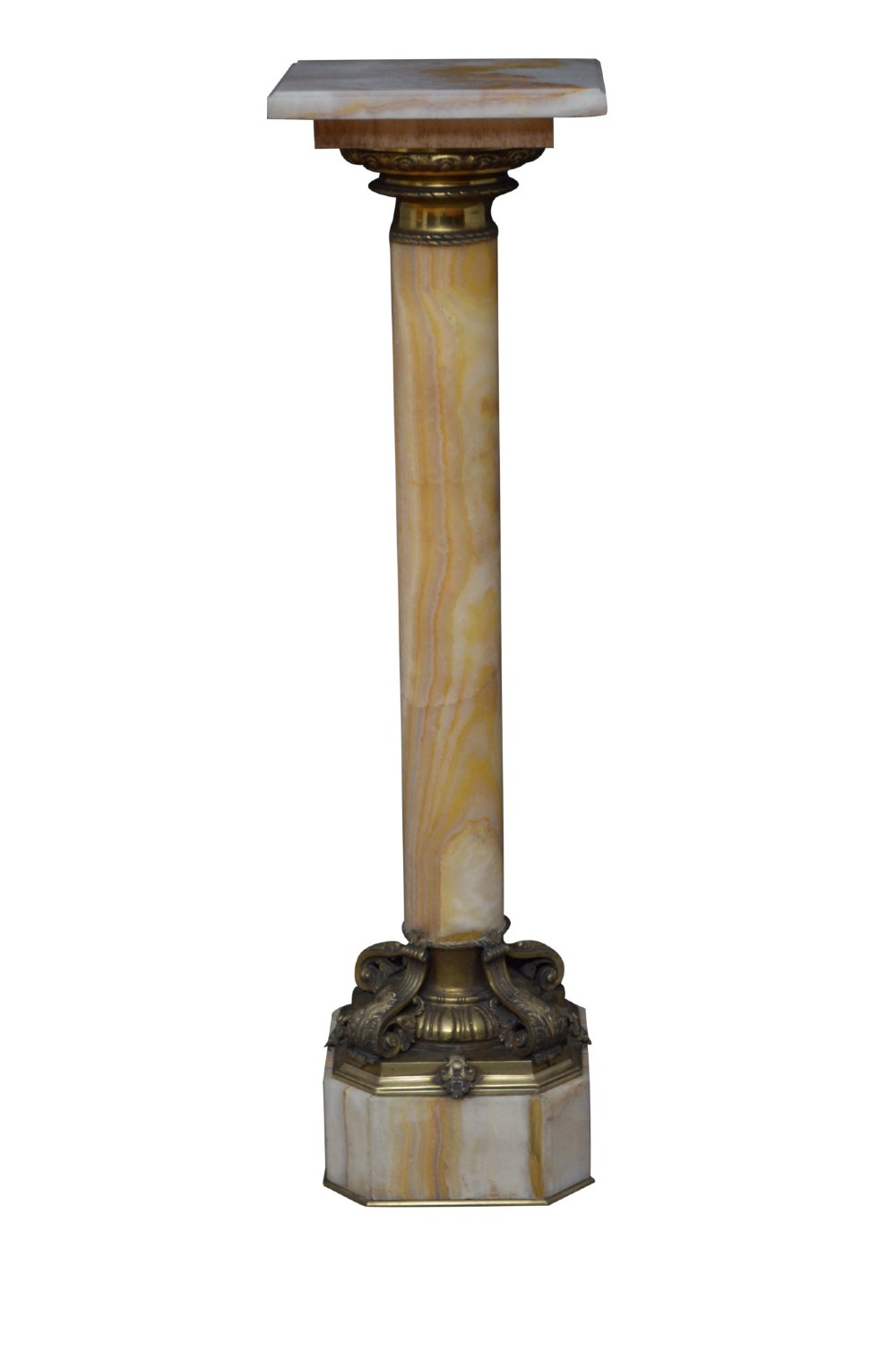 A tall cylindrical cream and amber onyx column featuring gilt bronze ormolu mounts at the top and base, set on a square plinth. View XV