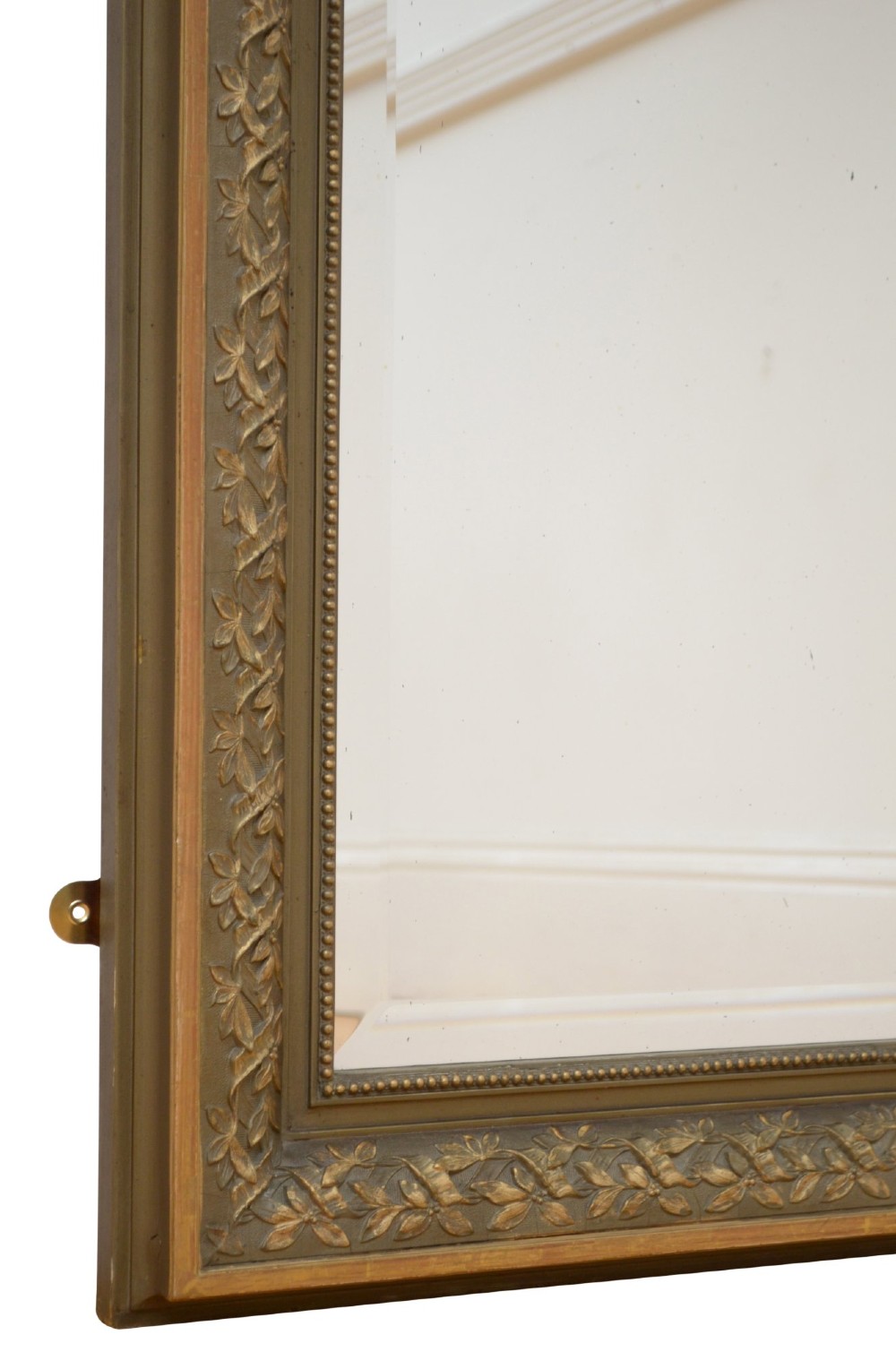 A large rectangular French wall mirror featuring a gilded wood frame, an olive green painted frieze decorated with carved floral swags, and an ornate ribbon bow crest. View XIII