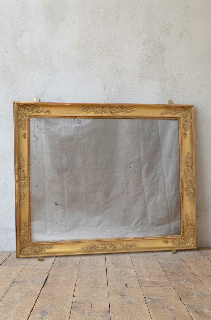 A rectangular French Restoration giltwood wall mirror featuring carved floral mouldings and distressed mirror glass. View XII