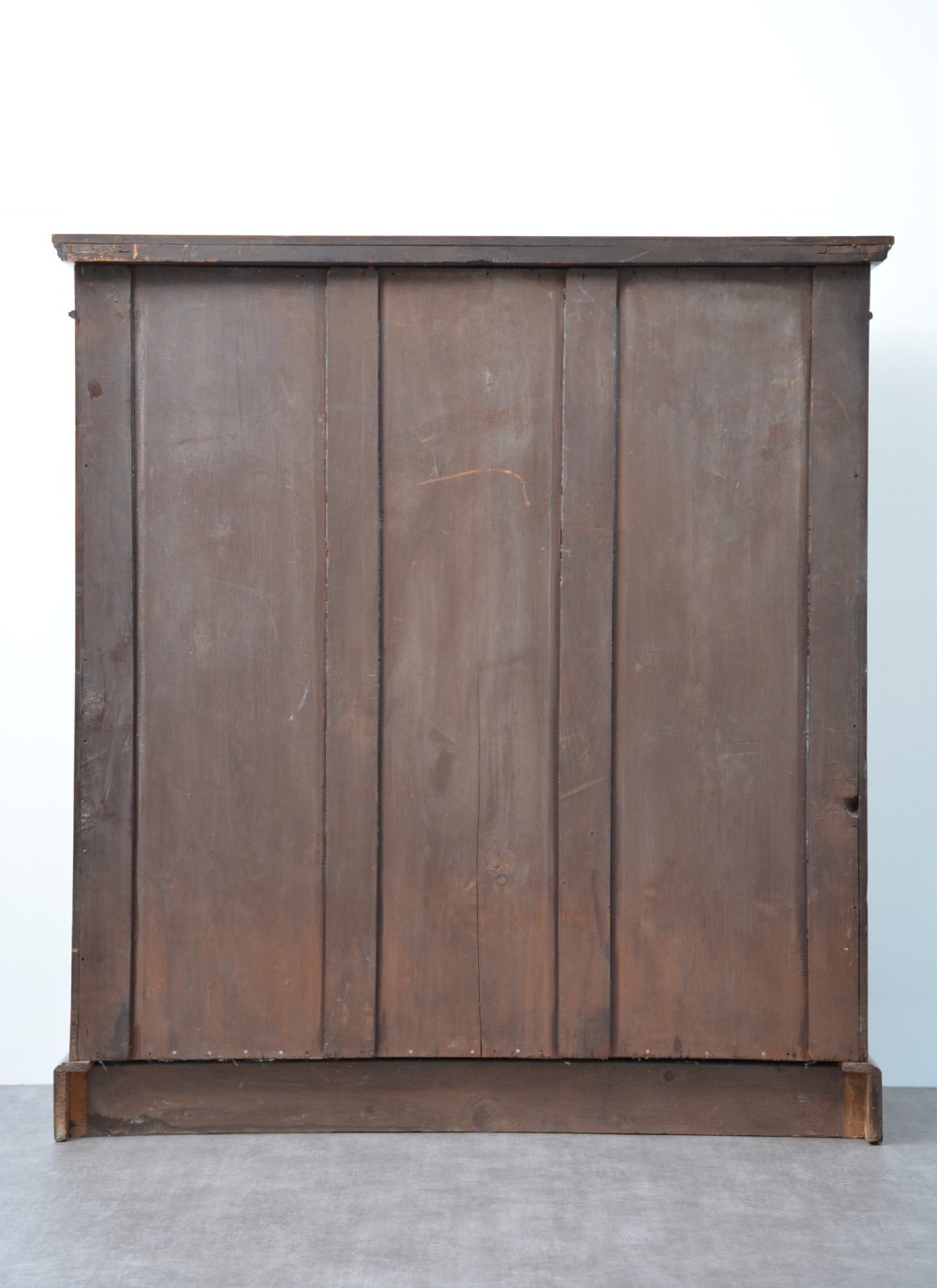 A late Victorian open walnut bookcase featuring a carved rosette frieze, moulded top cornice, adjustable shelves, and a solid plinth base. View XV
