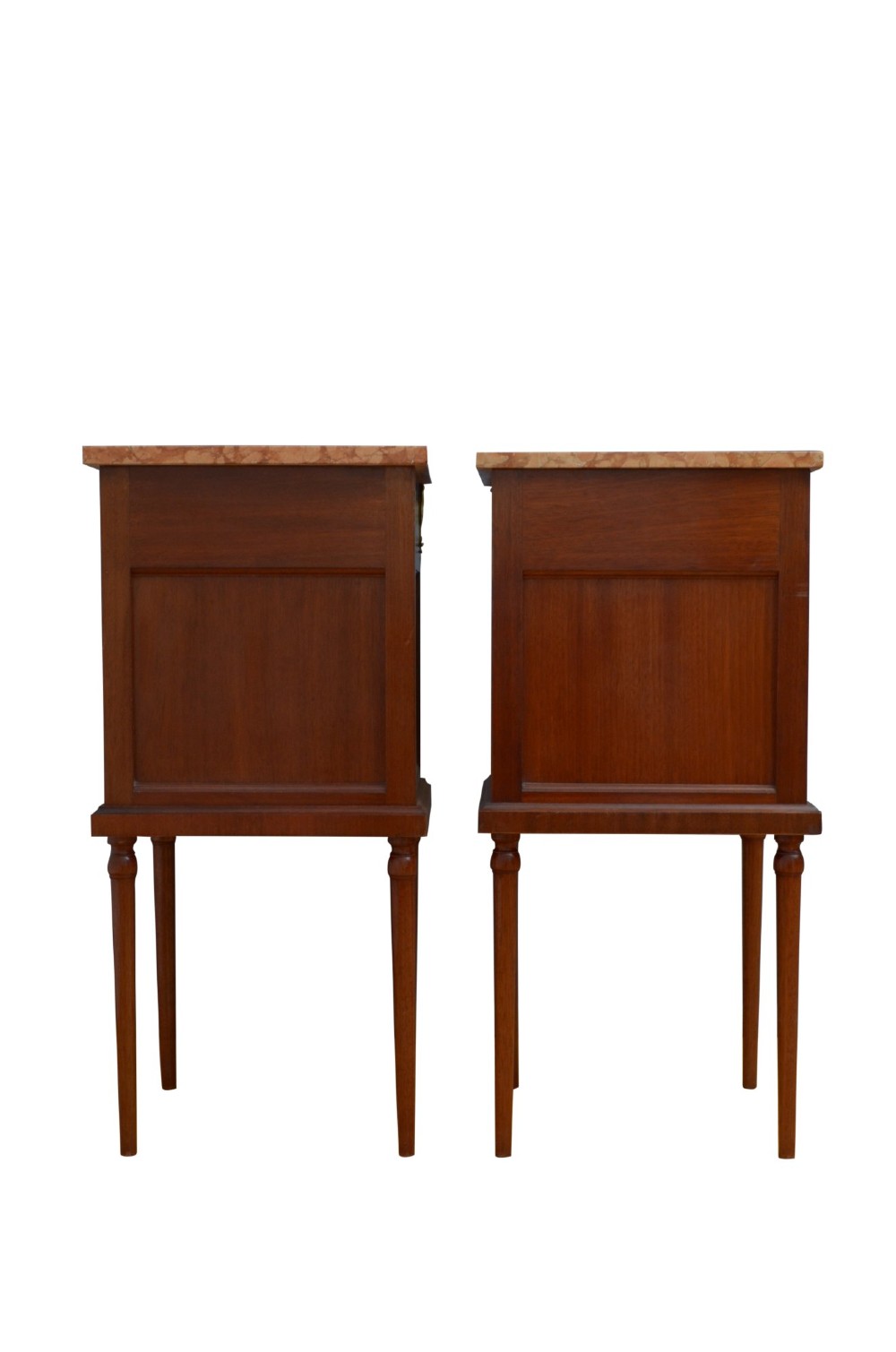A matching pair of French mahogany bedside cabinets featuring pink marble tops, single drawers over small cupboards with sunburst parquetry, and slender turned legs. View VIII
