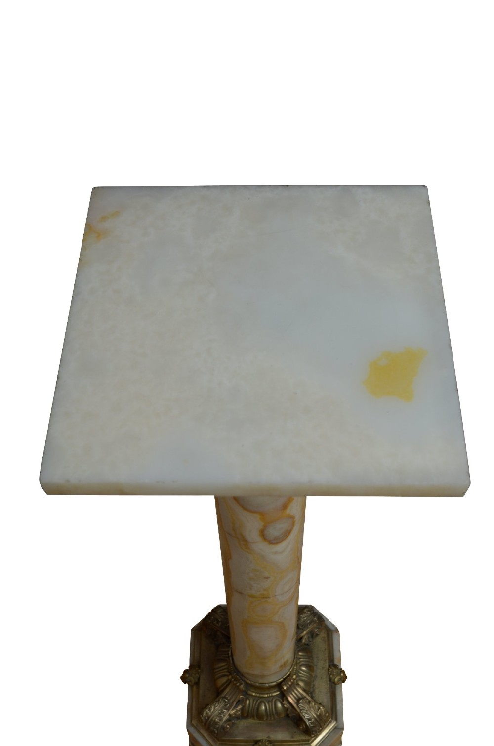 A pair of tall cylindrical onyx marble pedestals with square top plinths and ornate gilt ormolu collars and bases. View V
