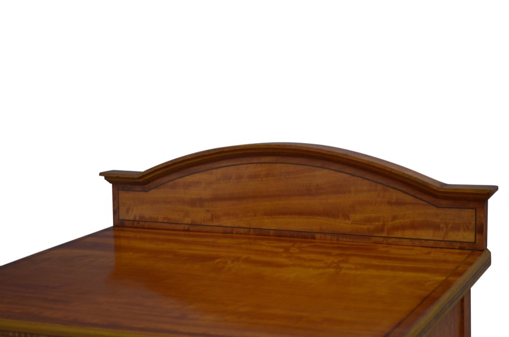 An antique satinwood bedside cupboard featuring a shaped gallery back, top drawer, chevron parquetry cupboard door, and slender fluted legs. View IV