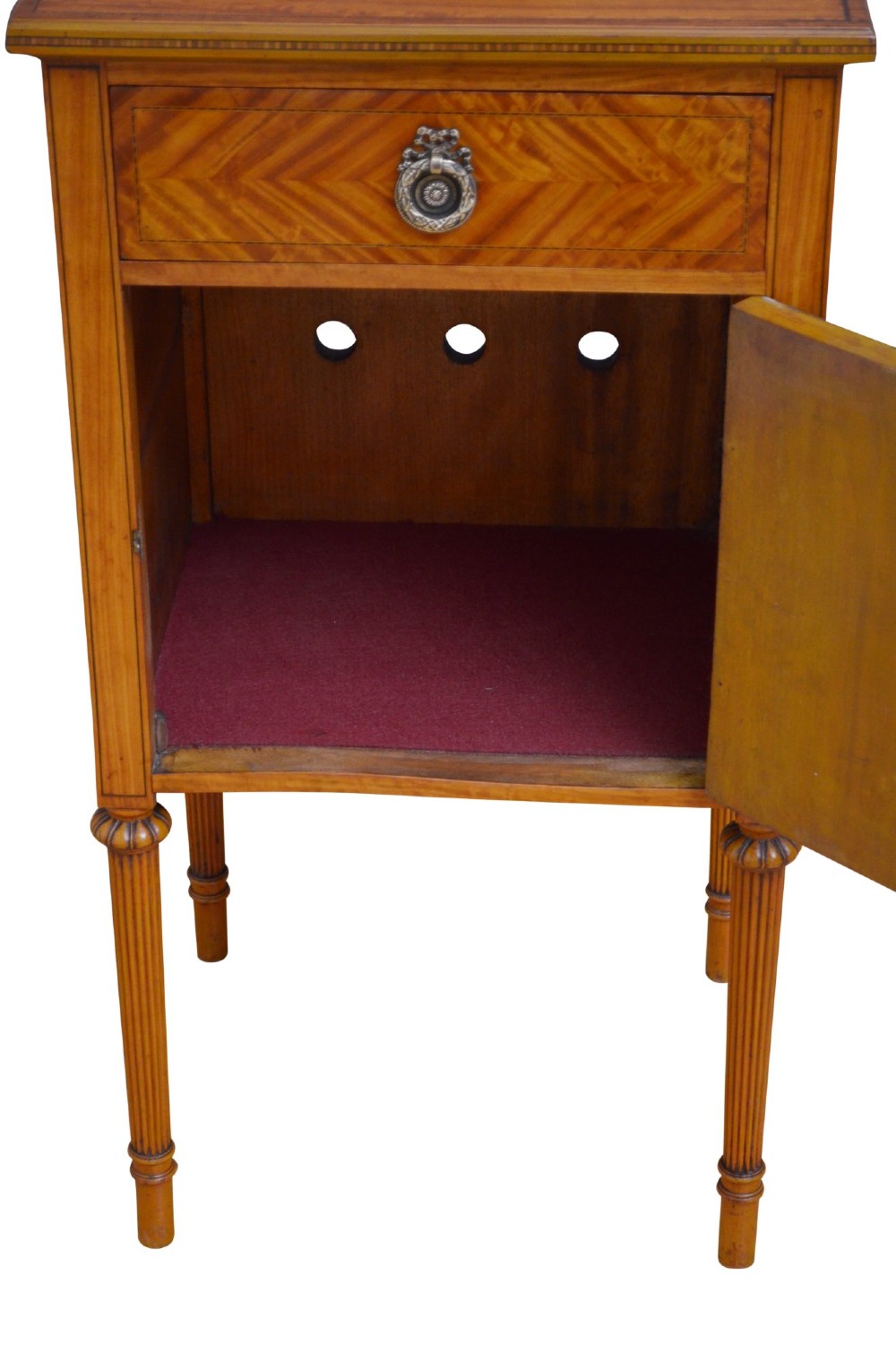 An antique satinwood bedside cupboard featuring a shaped gallery back, top drawer, chevron parquetry cupboard door, and slender fluted legs. View VII