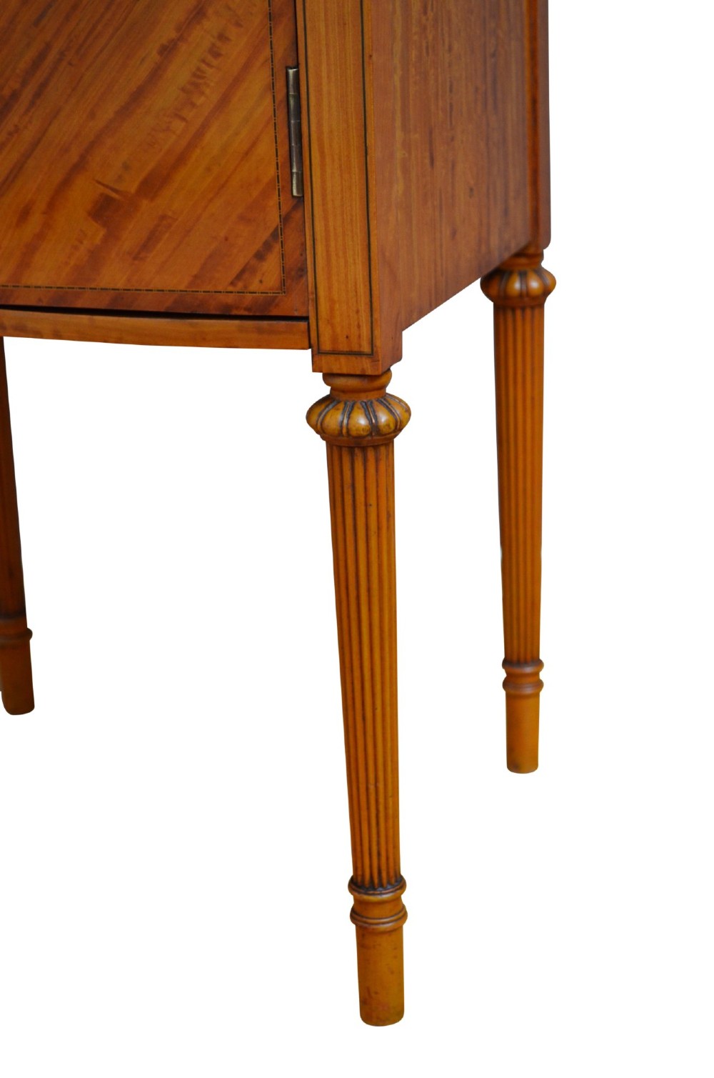 An antique satinwood bedside cupboard featuring a shaped gallery back, top drawer, chevron parquetry cupboard door, and slender fluted legs. View X