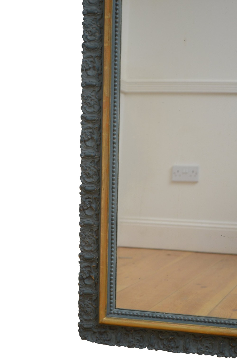 A tall French Empire style pier mirror featuring a carved grey painted frame with an ornate acanthus crest and a gilded inner slip border. View VII