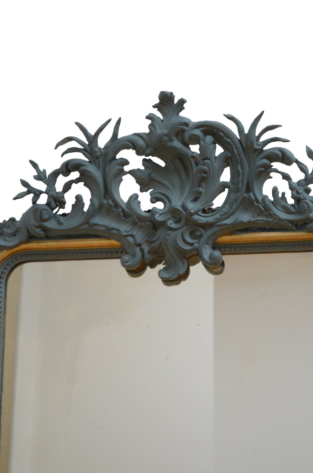 A tall French Empire style pier mirror featuring a carved grey painted frame with an ornate acanthus crest and a gilded inner slip border. View IX