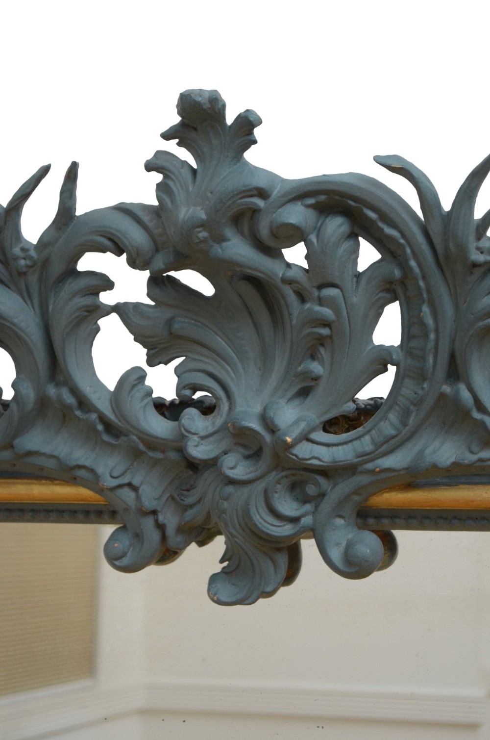 A tall French Empire style pier mirror featuring a carved grey painted frame with an ornate acanthus crest and a gilded inner slip border. View XII