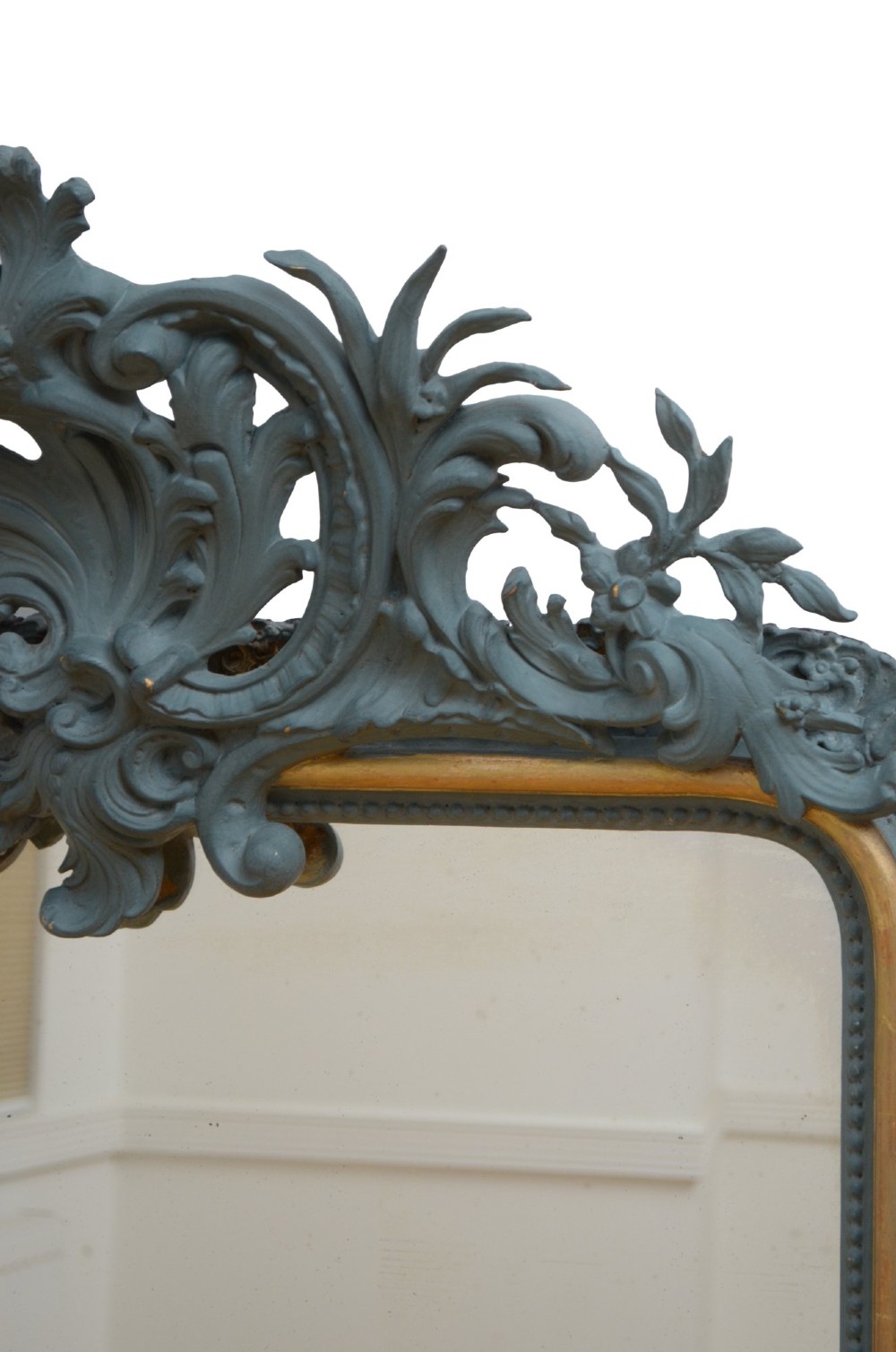 A tall French Empire style pier mirror featuring a carved grey painted frame with an ornate acanthus crest and a gilded inner slip border. View XIII