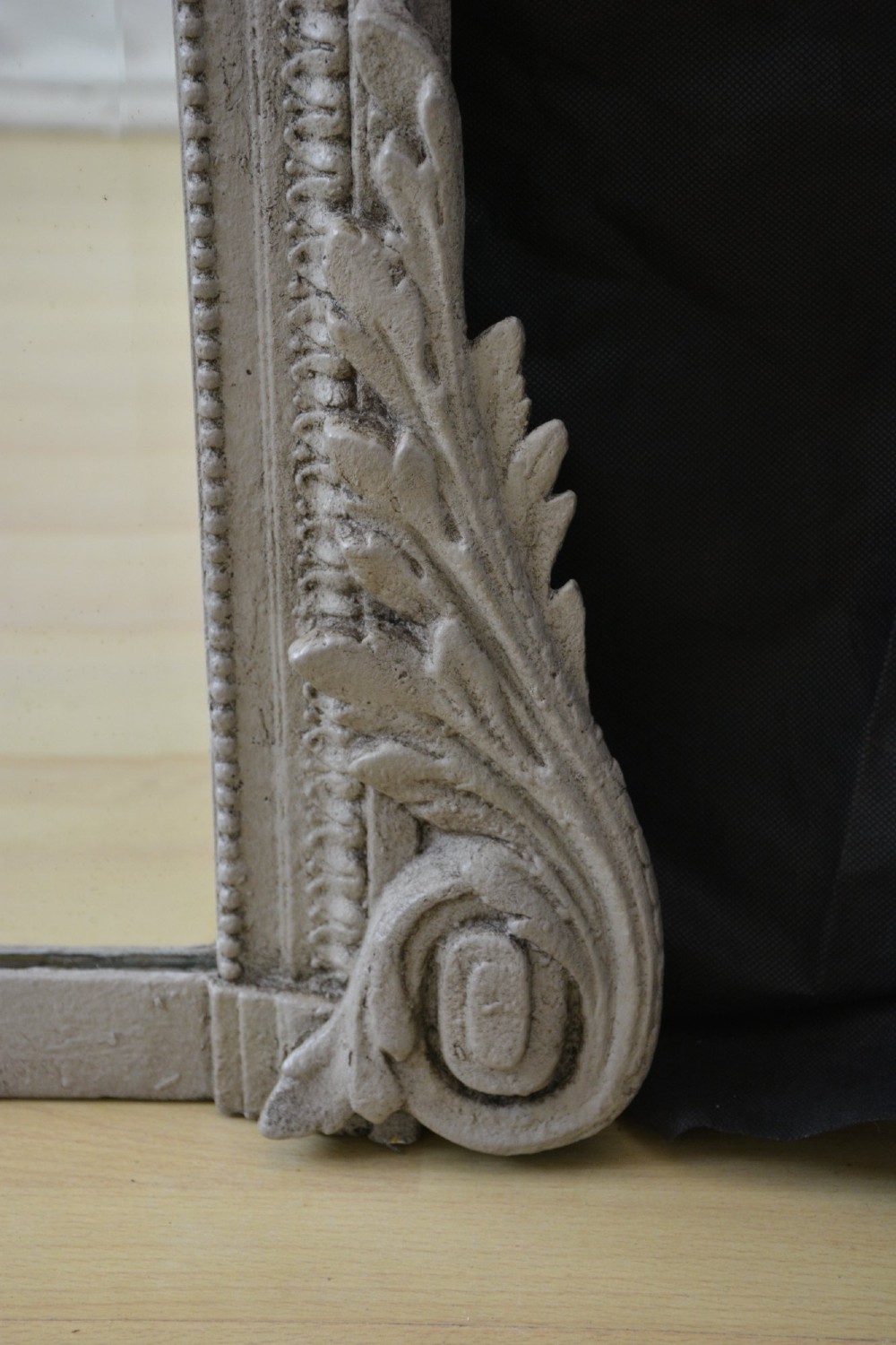 A light grey painted arched mirror featuring a carved ribbon bow crest and acanthus scroll corner details. View VI
