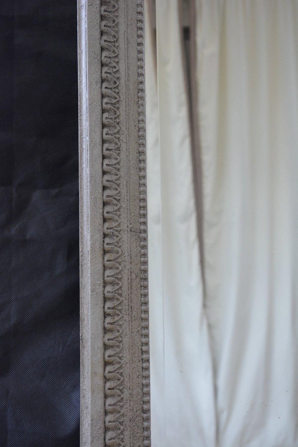 A light grey painted arched mirror featuring a carved ribbon bow crest and acanthus scroll corner details. View XIV