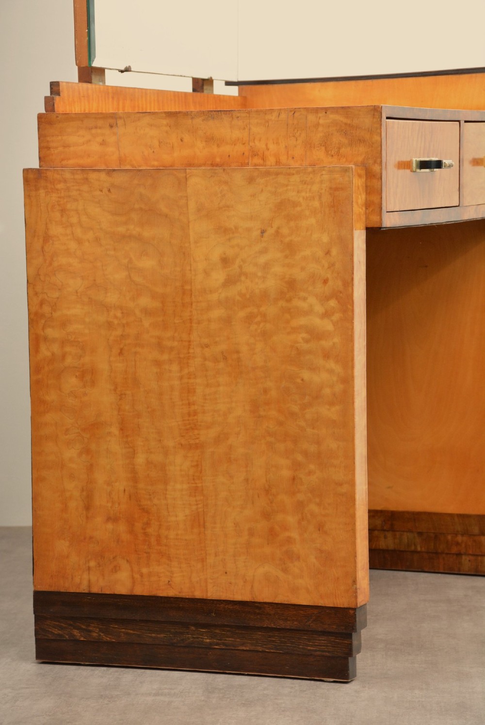 An Art Deco asymmetrical dressing table crafted in burr maple veneer with an offset pedestal of drawers and a large frameless mirror. View XIV