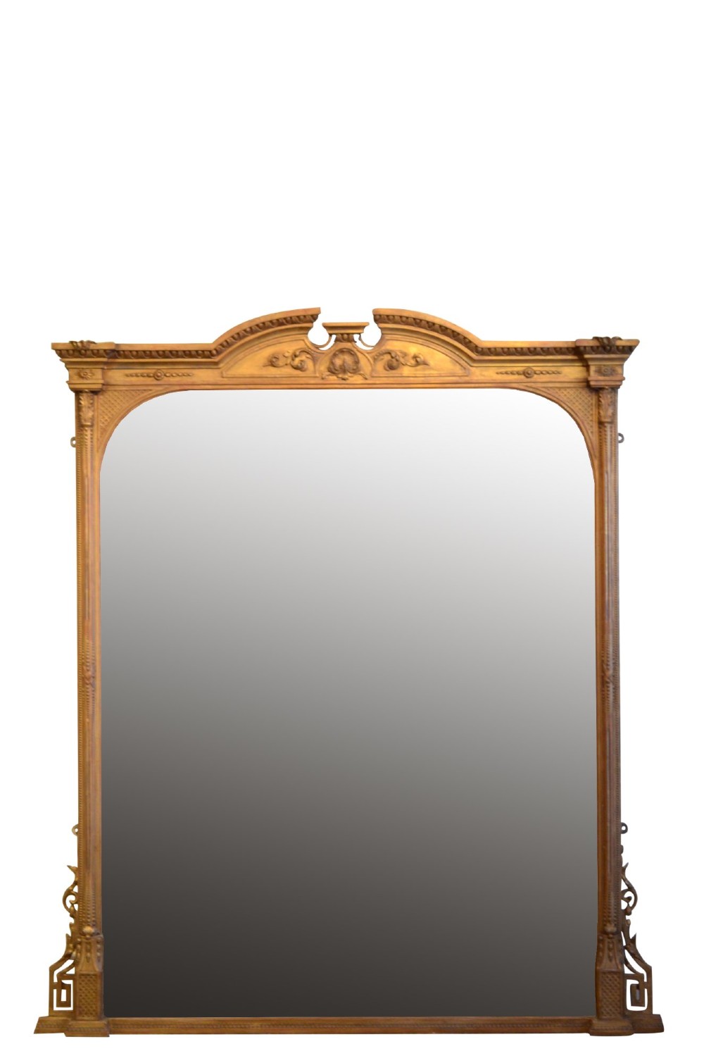 A large antique giltwood overmantel mirror featuring an arched top frame with carved cresting and decorative lower corner flourishes. View V