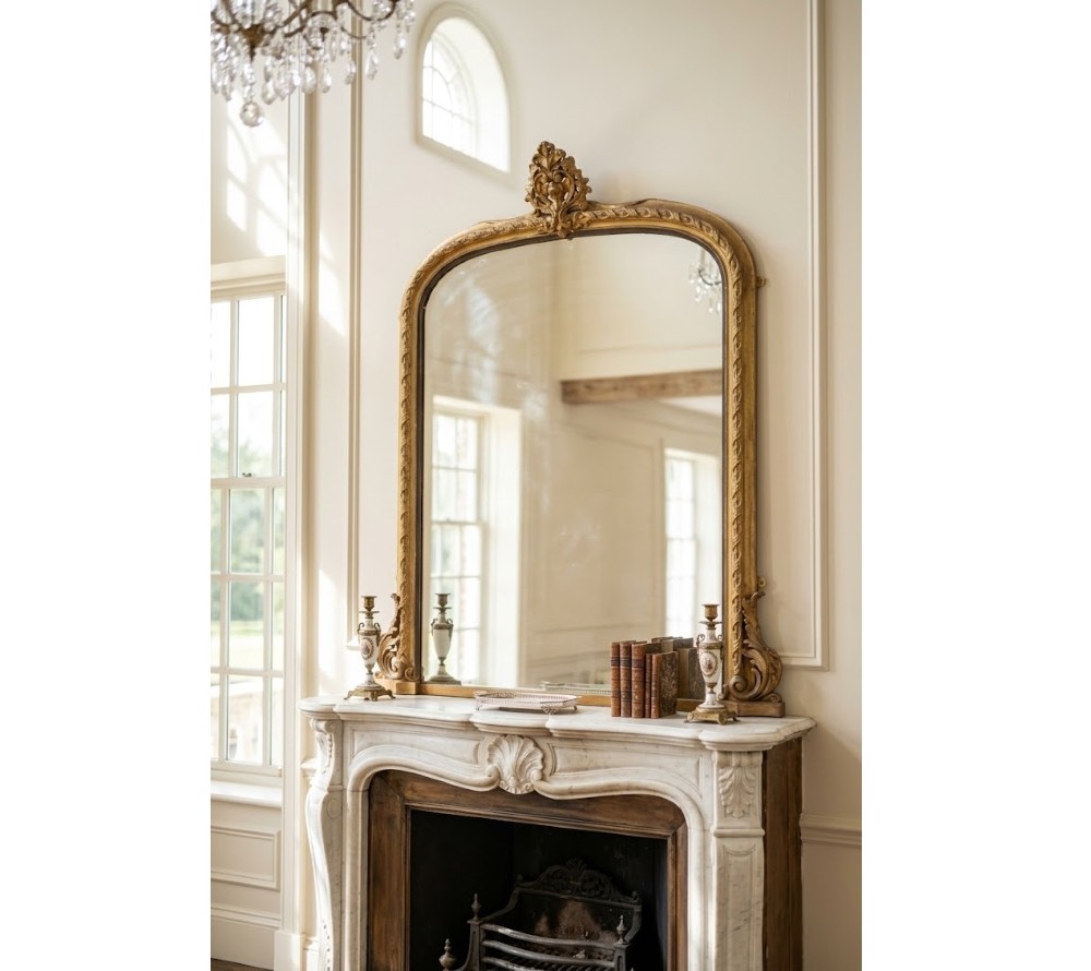 A large arched giltwood overmantel mirror featuring an ornate acanthus crest top and decorative side spandrels. View III