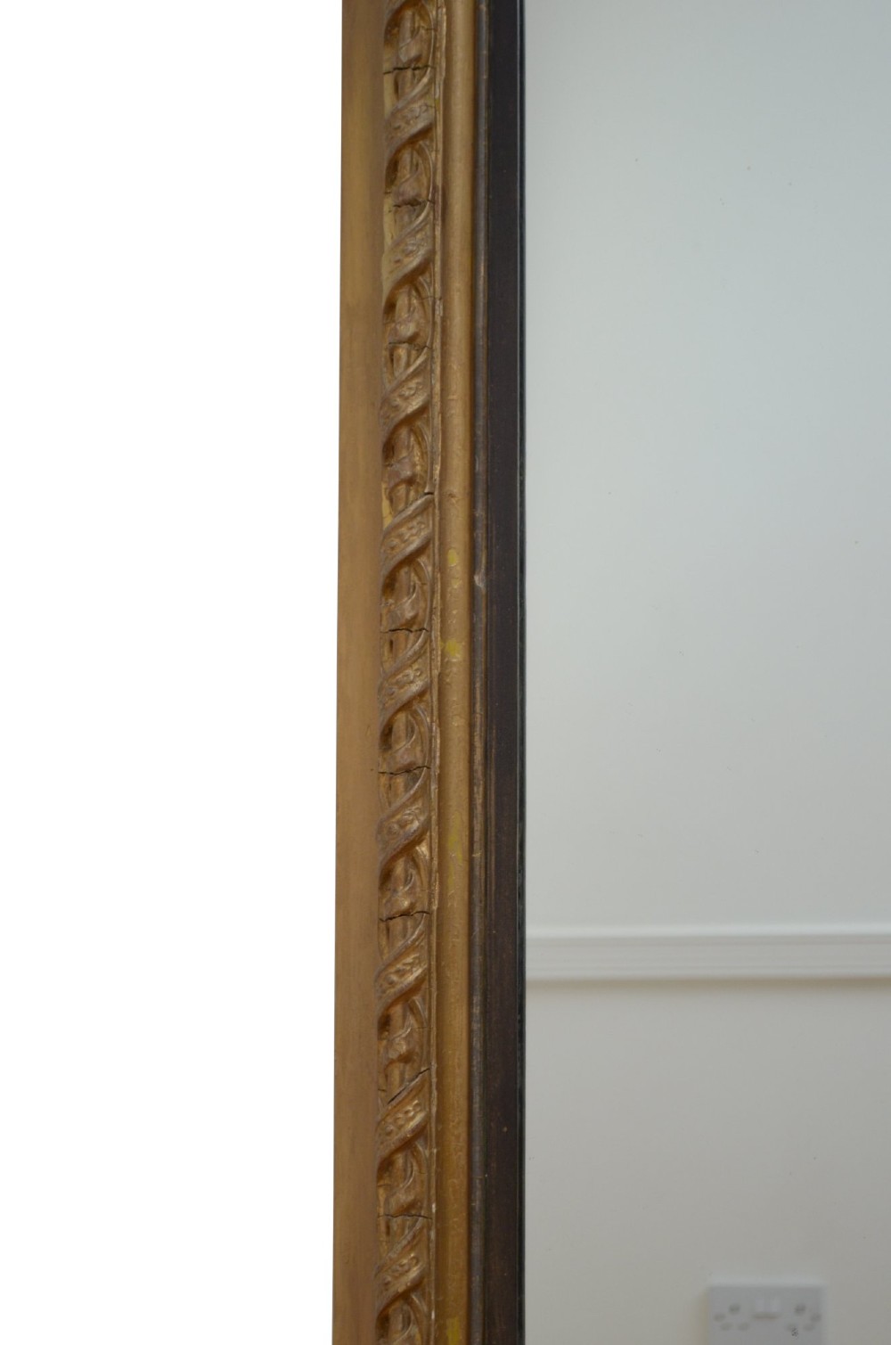A large arched giltwood overmantel mirror featuring an ornate acanthus crest top and decorative side spandrels. View V