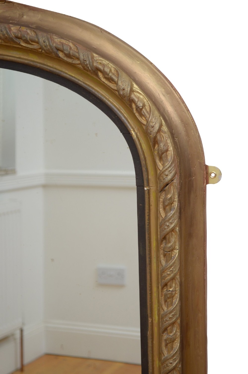 A large arched giltwood overmantel mirror featuring an ornate acanthus crest top and decorative side spandrels. View IX