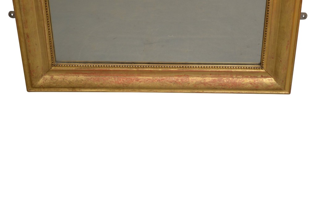 A tall arched French Napoleon III wall mirror featuring a gilded frame with a carved shell and foliage crest. View IV