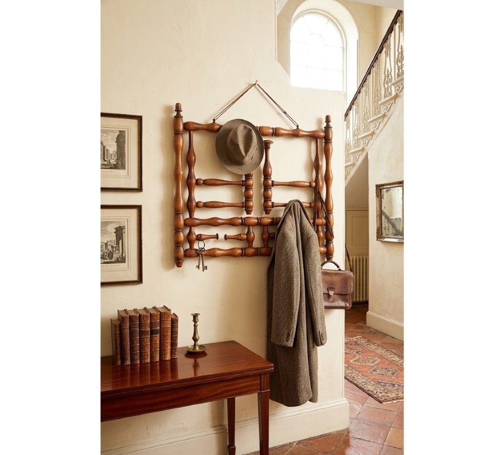 A French antique bobbin-turned wooden coat rack featuring swivelling upper hooks and fixed lower pegs suspended by a hanging cord. View XIII